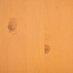 The photo shows a close-up of the surface of a beer table in pine finish.
