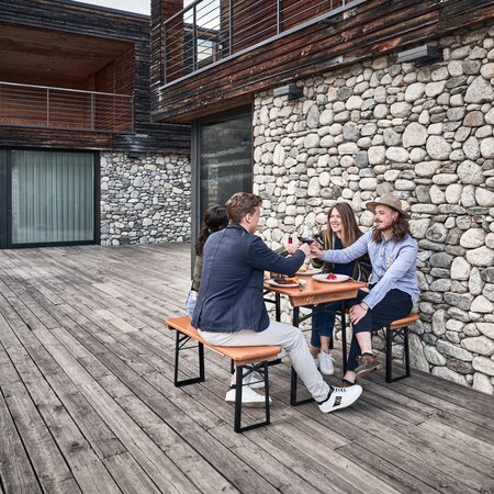 Beer garden table set Shorty on a terrace Four friends sit on the small beer garden table sets Shorty and toast together.