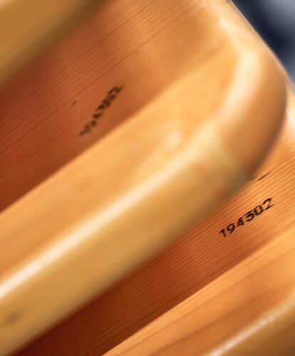Several wooden boards in pine are stacked on top of each other.