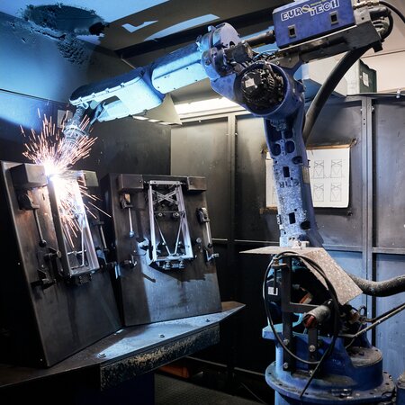 The photo shows a welding robot, automatically welding the frames for RUKU1952 beer tent sets.