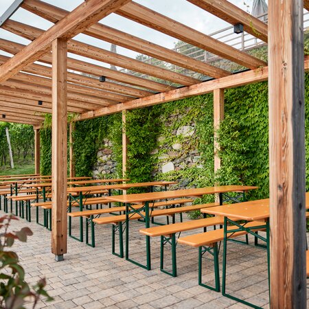 Classic beer garden table sets were set up on the terrace of Guggerhof.