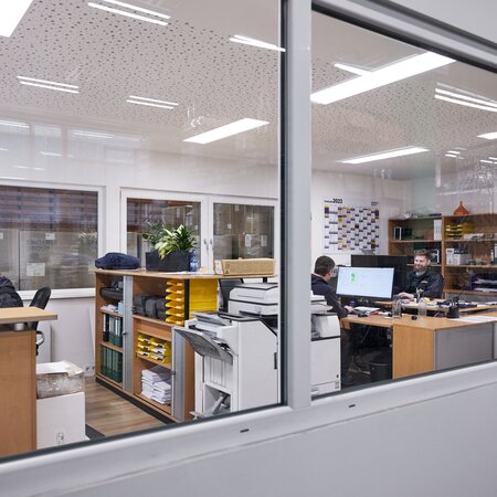 The photo shows an outside view into the production office.