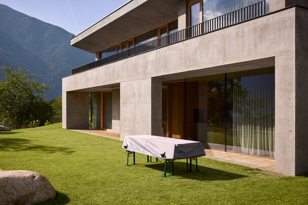 A beer garden table set is covered with an outdoor table cover.