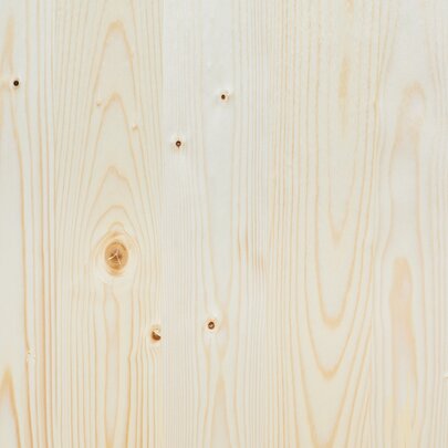 The wooden top of the beer garden table sets in nature.
