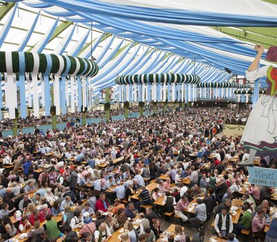 The photo shows the interior of an Oktoberfest tent.