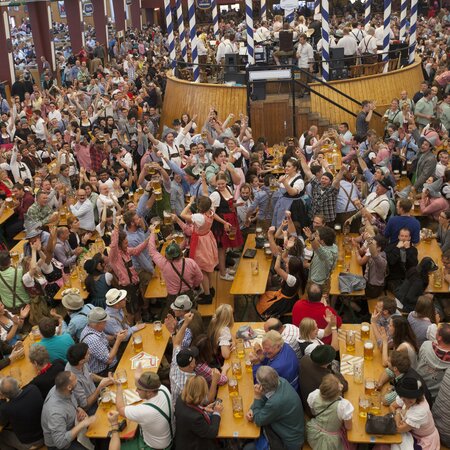 Many tables and benches of beer garden table sets with legroom at full Oktoberfest.