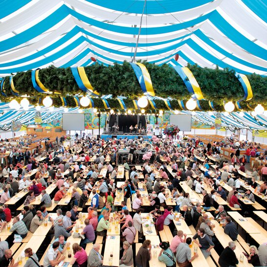 Classic beer garden table sets natural at oktoberfest The classic beer garden table sets in natural color at Oktoberfest.