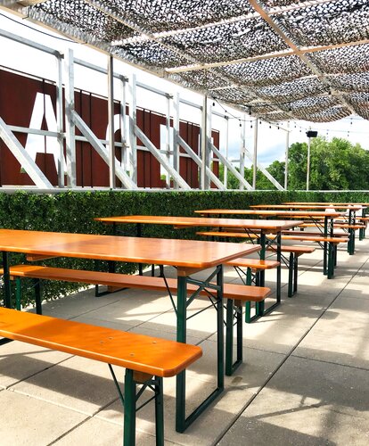 Classic beer tent sets in pine in an outdoor setting Classic tent set in pine finish are set up in the outdoor area of the Wooden Robot Brewery.